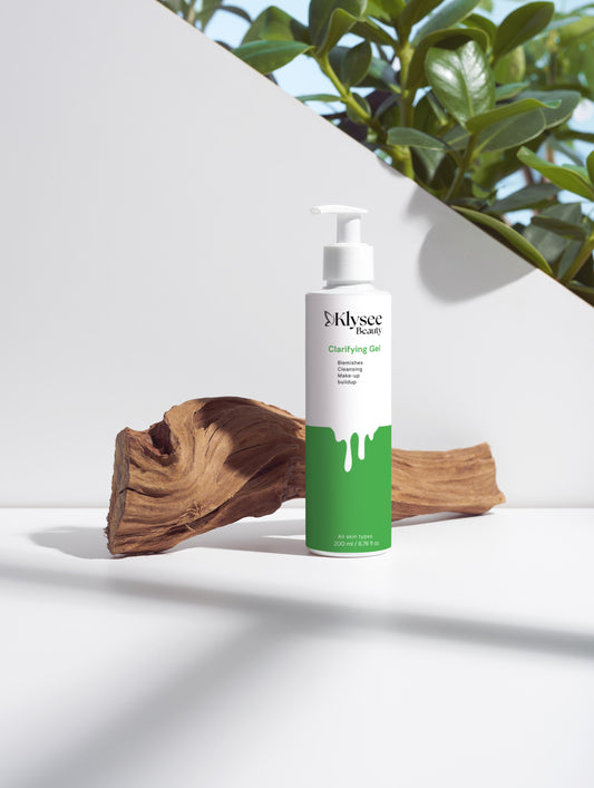 Mysean bottle with green label on a white surface with a plant in the background