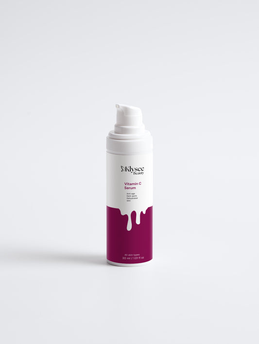 Skincare product with a white pump and purple label on a light gray background