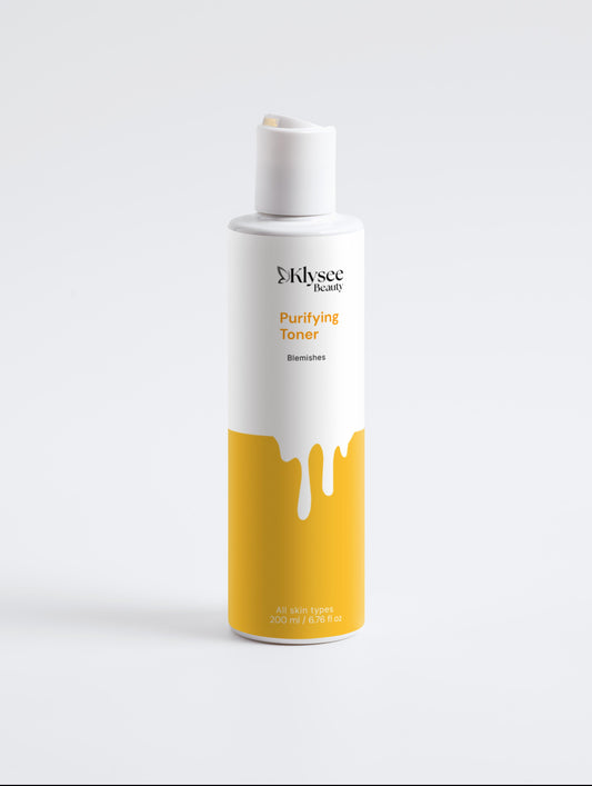 Klysee toner bottle with white cap and yellow label on a light gray background