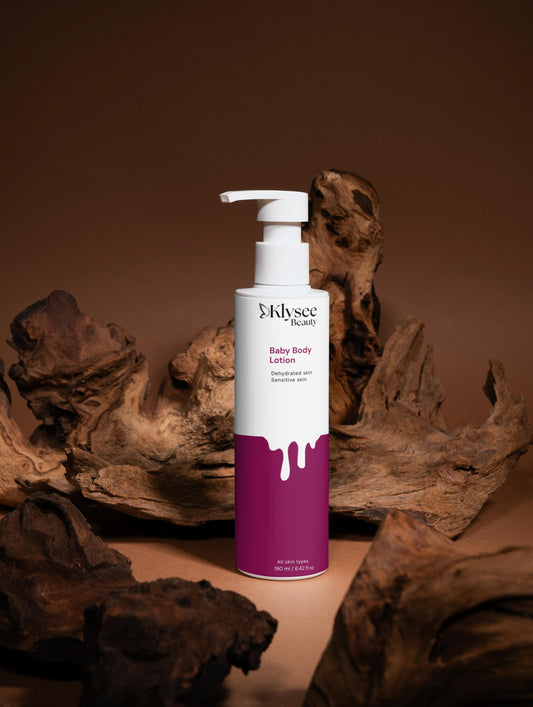 Baby body lotion bottle with purple label on a brown background