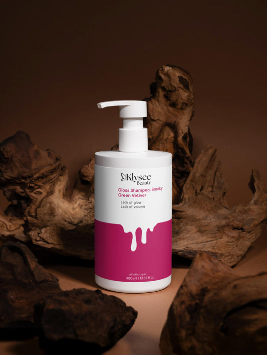 Shampoo bottle with pink label on a brown background