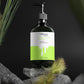 Bottle of Elysee Naturals product on a rock with grass and a dark background