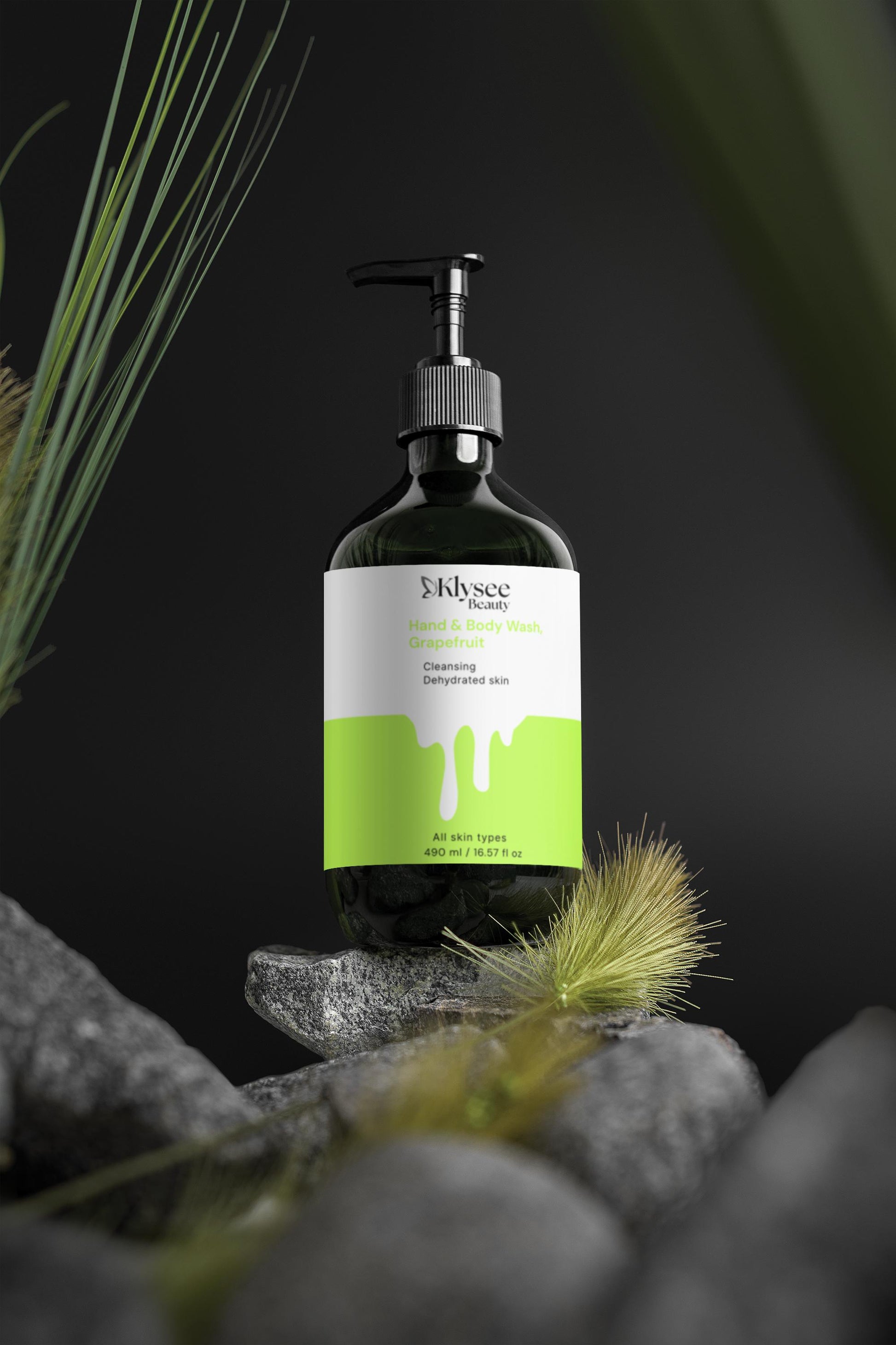 Bottle of Elysee Naturals product on a rock with grass and a dark background