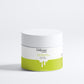 Klysee beauty product jar with white lid and green base on a white background