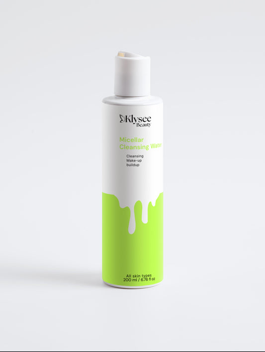 Skincare bottle with white cap and green label on a light gray background