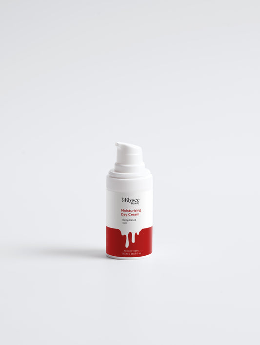 A person applying Klysee vegan day cream to their cheek for instant hydration and a dewy glow.