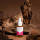 Skincare dropper bottle with pink label on a brown background
