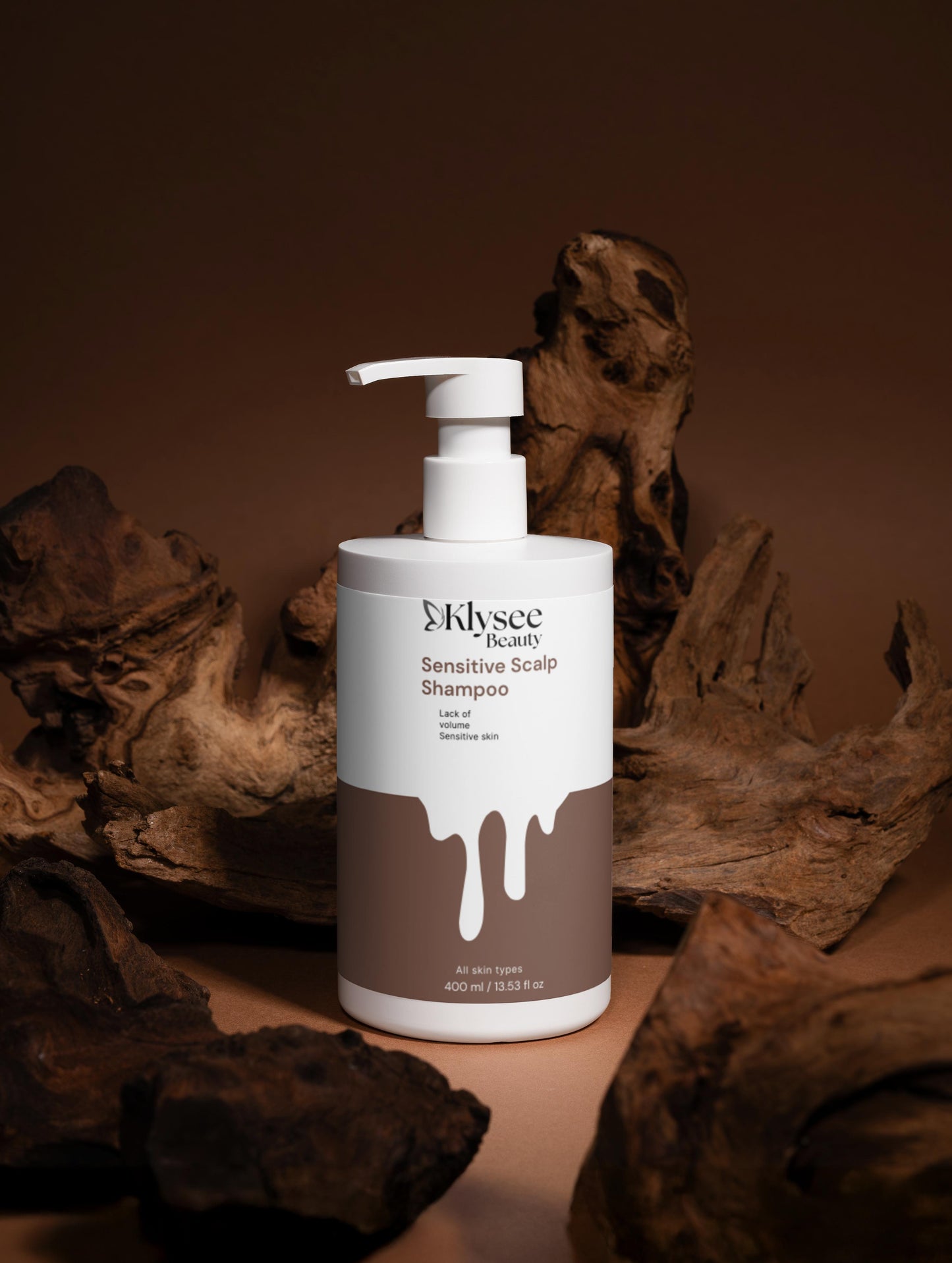 Klysee Beauty shampoo bottle with pump on a brown background