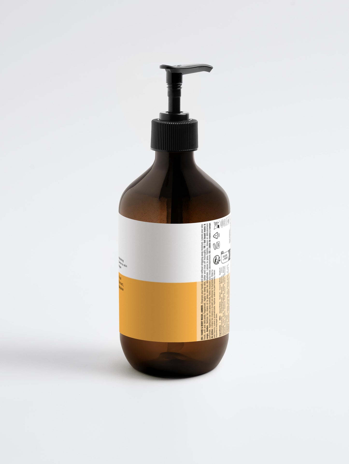 Brown bottle with pump and yellow label on a white background